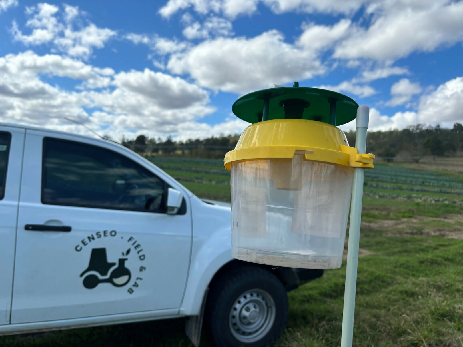Pheromone trap mounted on a field vehicle for pest monitoring